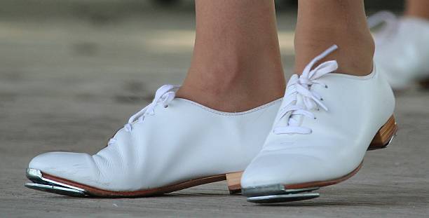 White shoes with clogging taps.